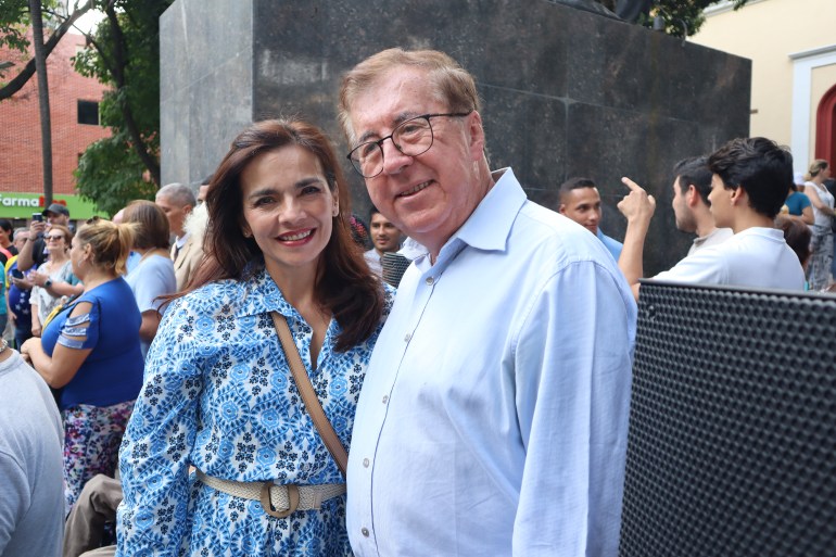 Cesar Vivas Perez poses for a photo with an acquaintance outdoors in Venezuela.