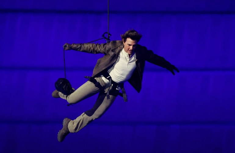 US' actor Tom Cruise jumps from the roof of the Stade de France during the closing ceremony of the Paris 2024 Olympic Games at the Stade de France, in Saint-Denis, in the outskirts of Paris, on August 11, 2024. (Photo by Phil Noble / POOL / AFP)