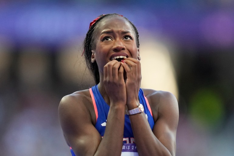 Cyréna Samba-Mayela, of France, reacts after winning the silver medal in the women's 100 meters hurdles final at the 2024 Summer Olympics, Saturday, Aug. 10, 2024, in Saint-Denis, France. (AP Photo/Ashley Landis)