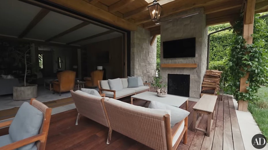 The patio features a TV, plenty of seating and a fireplace.