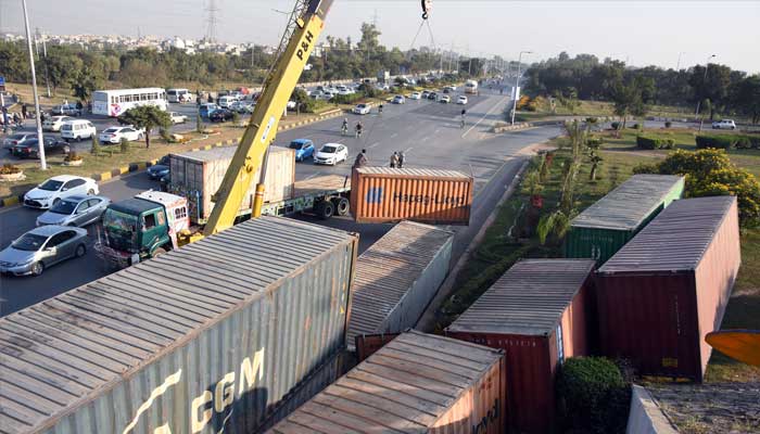 Authorities place heavy shipping containers near Faizabad flyover along Islamabad Highway for road block ahead of upcoming PTI protest in Islamabad on November 21, 2024. — Online