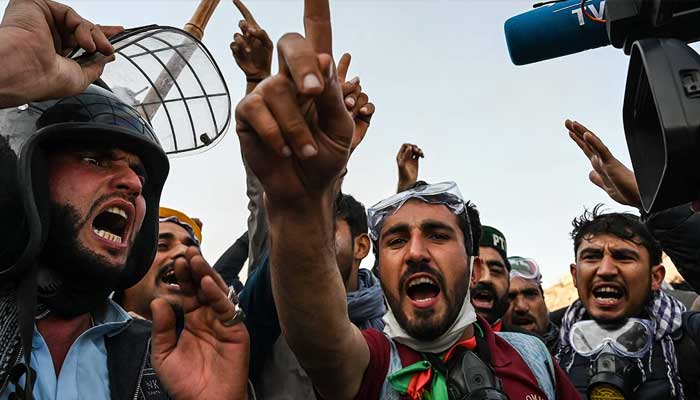 Supporters of jailed former prime minister Imran Khans PTI shout slogans as they march towards Islamabad after clearing containers in Hasan Abdal in Punjab province on November 25, 2024. — AFP